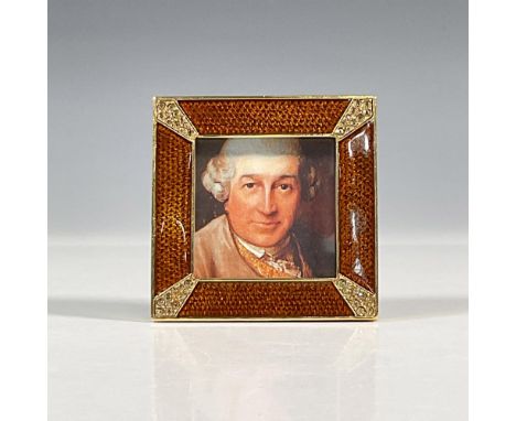 A small, classic amber frame, hand enameled and set with Swarovski crystals in each pave corner. The back features a hand-ena