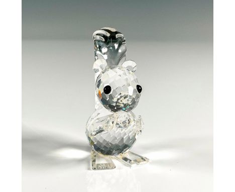 Multifaceted clear crystal with black eyes holding a nut. Swarovski etched backstamp. This item has its original box, 2.5"H x