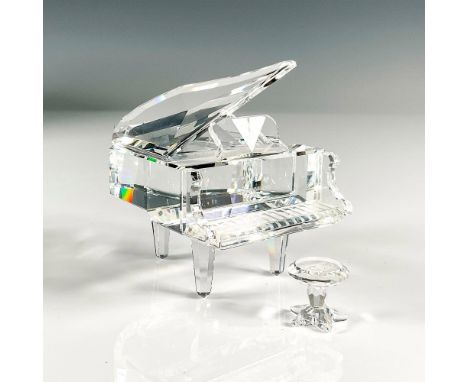 Clear crystal representation of a beautiful piano with frosted keys and Swarovski mark on front. Crystal round stool included
