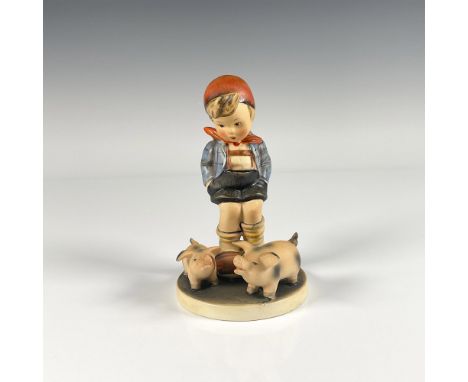 Hand painted in matte finish porcelain figure. Features a little German boy watching two pigs play in dirt. Goebel backstamp.