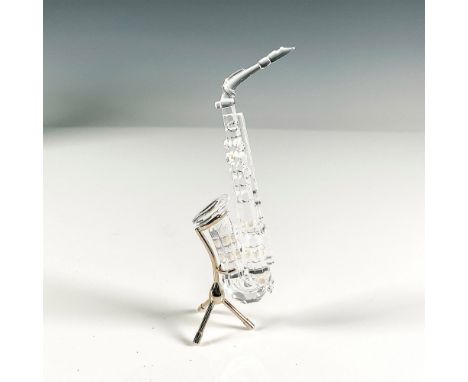 Clear faceted body with simulated pearls on hole covers. Figural has stand for instrument. Swarovski etched backstamp. This i