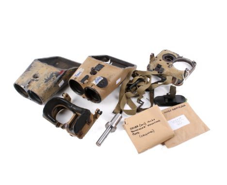 An assortment of WWII and later military binocular components. Including eyepieces, a mounting plate, cases and more