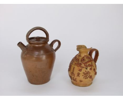 A 19th century west country pottery ewer with relief moulded clay decoration incorporating fruiting vine, agricultural tools,