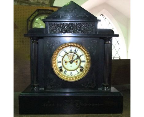 An Ansonia black slate mantle clock of classical outline with visible escapement and 8 day striking movement (with key and pe