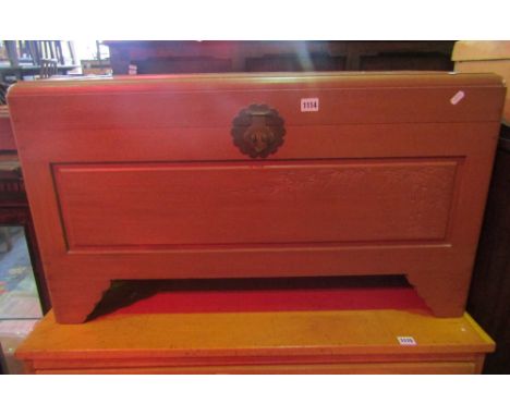 An Eastern camphor wood blanket box with hinged lid, brass lock plate and scratch carved bamboo detail and raised on shaped b