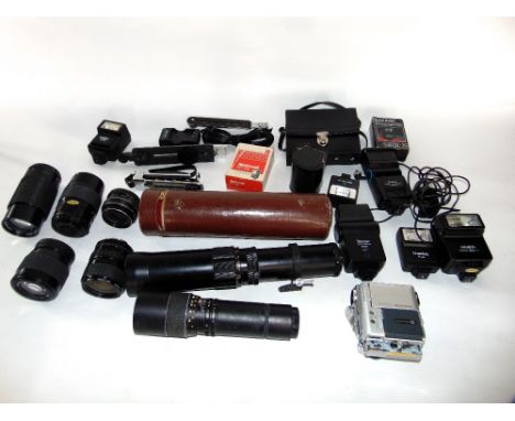 A collection of vintage photographic accessories to include various flash guns and lenses including examples by Minolta, Sigm