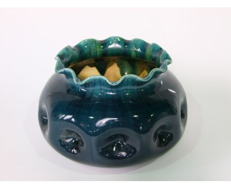 An early 20th century Linthorpe pottery jardinière with dark blue and turquoise graduated glaze and dimpled finish and shaped