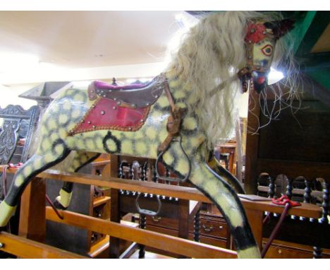 A vintage rocking horse with dapple grey finish raised on a central rocker, overall height 1 m, overall length 120 cm approx