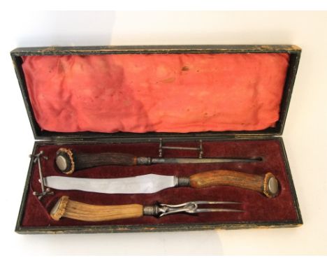 A boxed antique carving trio, fork, knife and steel, the steel stamped Wade & Butcher, Heffield, England, together with a pai