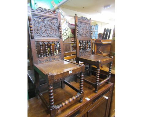 A pair of Victorian carved oak side or hall chairs, the backs with carved panels, turned spindle and other detail, solid seat