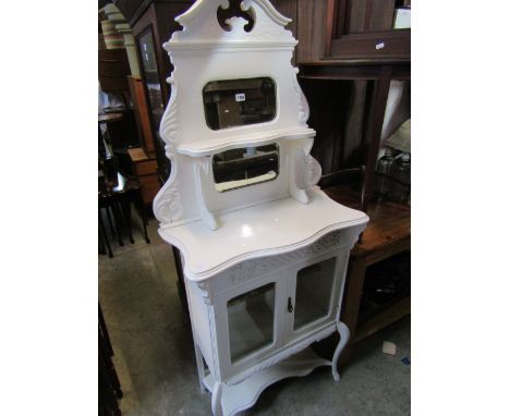 An Edwardian freestanding side cabinet/chiffonier with later painted finish, the raised back with shaped outline, scrolled ac