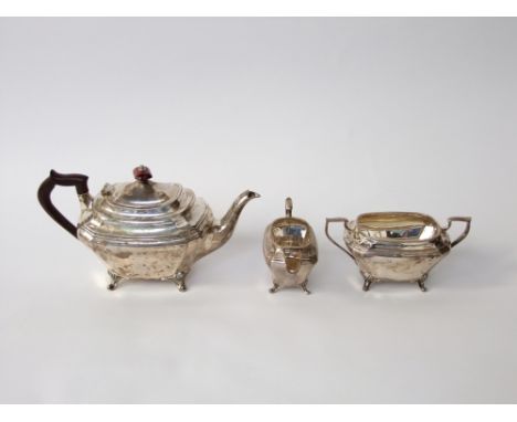 A silver three piece tea set, teapot, sugar basin and milk jug, each body of rectangular form with canted corners, Sheffield 