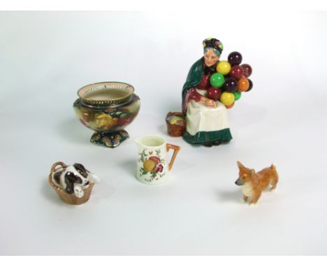 A Royal Doulton model of a brown and white spaniel puppy in a basket HN2586, a Royal Worcester model of a Corgi 3243, a Royal