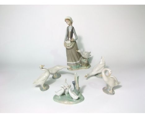 A Lladro figure group of a girl carrying a gosling in her apron accompanied by a goose together with five further Lladro and 