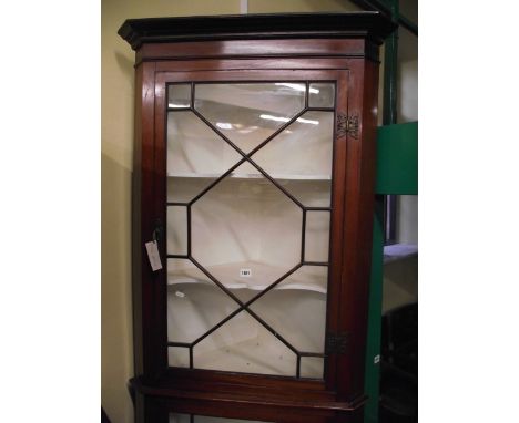 A 19th century mahogany two tier freestanding corner cupboard with two astragal glazed panelled doors, brass butterfly hinges