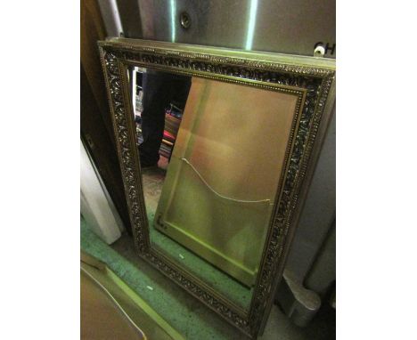 A contemporary gilt framed wall mirror of rectangular form with bevelled edge plate and moulded surround together with one ot