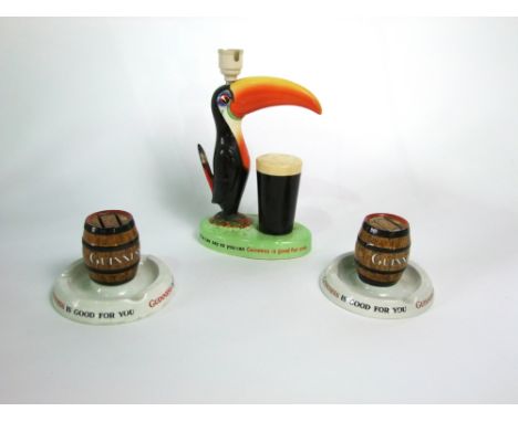 A Carltonware Guinness advertising lamp base with applied figure of a toucan and a pint of Guinness, raised on an oval base a