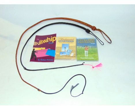 Two good quality woven leather whips, one tan, the other black together with related DVDs - Fundamental Whip Cracking Techniq