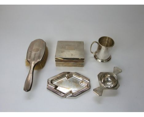 A silver cigarette case, engine turned detail, Art Deco ashtray, tea strainer, christening mug and silver backed brush, estim