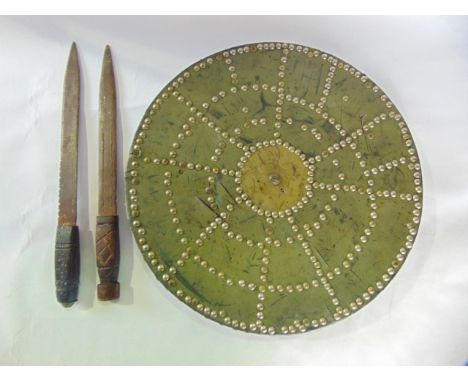 A reproduction early Scottish circular studded shield, together with a pair of timber handled knives, believed to have been u