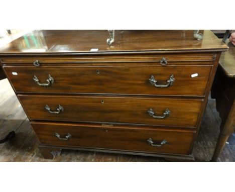 A Georgian mahogany chest of three long drawers accompanied by brush slide with adjustable baize lined writing slope, raised 