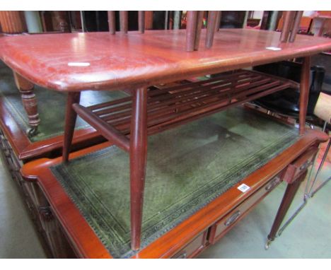 An Ercol medium to dark stained elm and beechwood occasional table of rectangular form with moulded outline, raised on splaye