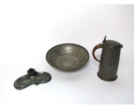 An early 20th century Tudric pewter hot water jug with cover, with scrolling decoration in the art nouveau manner, with a wic