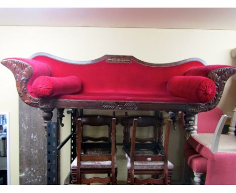 A Regency mahogany and brass inlaid sofa with swept supports, acanthus and other carved detail, raised on turned supports, 23