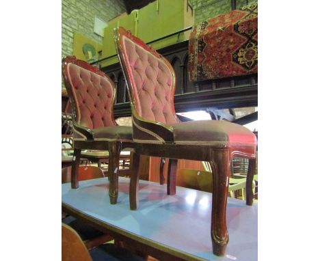 A pair of Victorian style spoonback drawing room or bedroom chairs with upholstered seats and button backs within stained bac