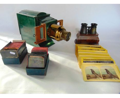 An early 20th century 'Boys Own' magic lantern slide projector together with approximately 58 coloured glass slides subjects 