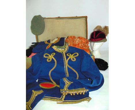A vintage canvas covered trunk to include an interesting selection of antique clothing costumes