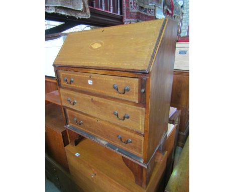 An inlaid Edwardian mahogany writing bureau with satinwood banding and shell detail, the fall flap enclosing a simply fitted 