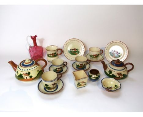 A collection of Torquay Pottery wares including two teapots, a milk jug of four sided form, a further milk jug, four cups, fo