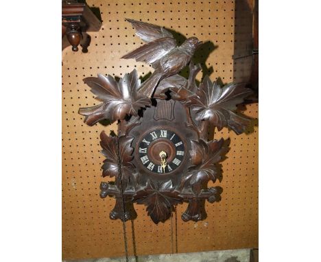 A Tyrolean cuckoo clock, the case of chalet form with applied detail (with cone shaped weight and pendulum)
