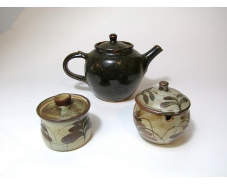 Two Studio Pottery lidded vessels by David Leach both with painted stylised leaf decoration in brown on an oatmeal coloured g