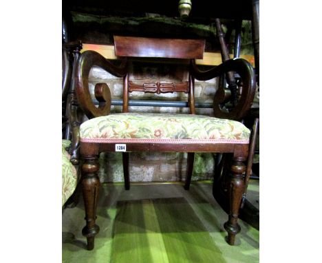 A Victorian nursing/low drawing room chair with upholstered seat and cameo shaped padded back within a walnut showwood frame 