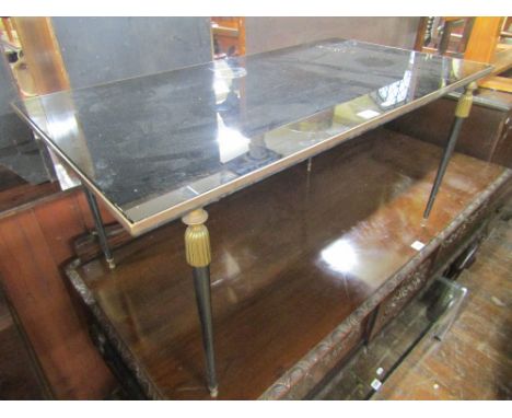 A vintage occasional table of rectangular form, the black plate glass top supported on four turned and tapering steel support