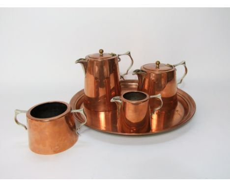 An English made lined copper drinks set comprising tea pot, hot water pot, two handled sugar basin and milk jug all with appl