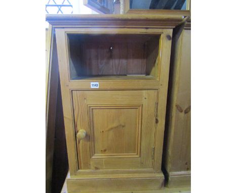 A pair of pine bedside cupboards, each enclosed by a square moulded panelled door beneath an open shelf/compartment