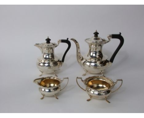 A silver four piece tea and coffee set, teapot, sugar basin and milk jug, each of cylindrical form with whale tail outline, o