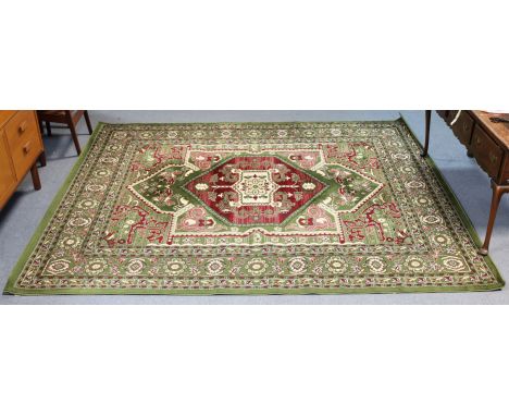 A similar modern Turkish carpet of green &amp; ivory ground &amp; with all-over multi-coloured floral design, 305cm x 244cm.