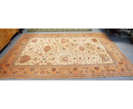 A Royal Keshan “Agra” wool carpet of cream ground &amp; with all-over multi-coloured geometric design within a multiple borde