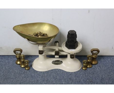 A white painted wooden four-tier dwarf standing open bookcase 77cm wide x 66cm high; and a pair of kitchen scales.