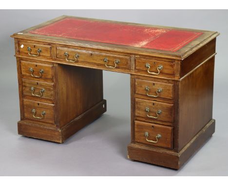 A Victorian mahogany pedestal desk inset gilt-tooled crimson leather, fitted with an arrangement of nine drawers, &amp; each 