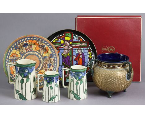 A Charlotte Rhead pottery fruit decorated dish 31cm diameter; a set of three Royal Doulton graduated jugs with poppy decorati