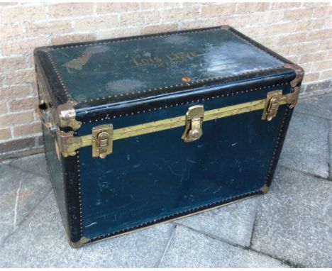 A VINTAGE BRASS BOUND TRAVELLING TRUNK  opening to fitted interior, with trade label for 'GENUINE NATIONAL VULCANINSED TRUNK 