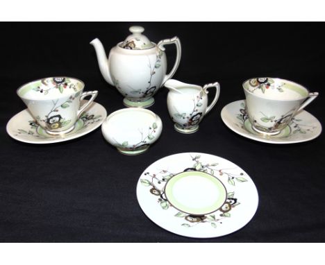 A ROYAL DOULTON TETE A TETE TEA SERVICE  decorated in the 'Veta' or 'Rega' pattern, the teapot 14cm high