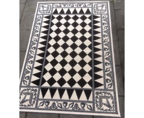 MASONIC INTERST: A CONTEMPORARY RUG  with central black and white chequerboard, square and compass motifs to each corner and 