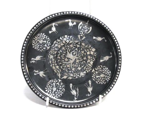 A BIDRI WARE SAUCER DISH  with silver inlaid decoration depicting birds and foliate motifs, 17.5cm diameter