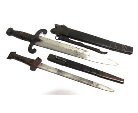 TWO GERMAN THEATRICAL DAGGERS  the largest with a 30cm steel blade, unmarked, in a leather scabbard with metal mounts, overal